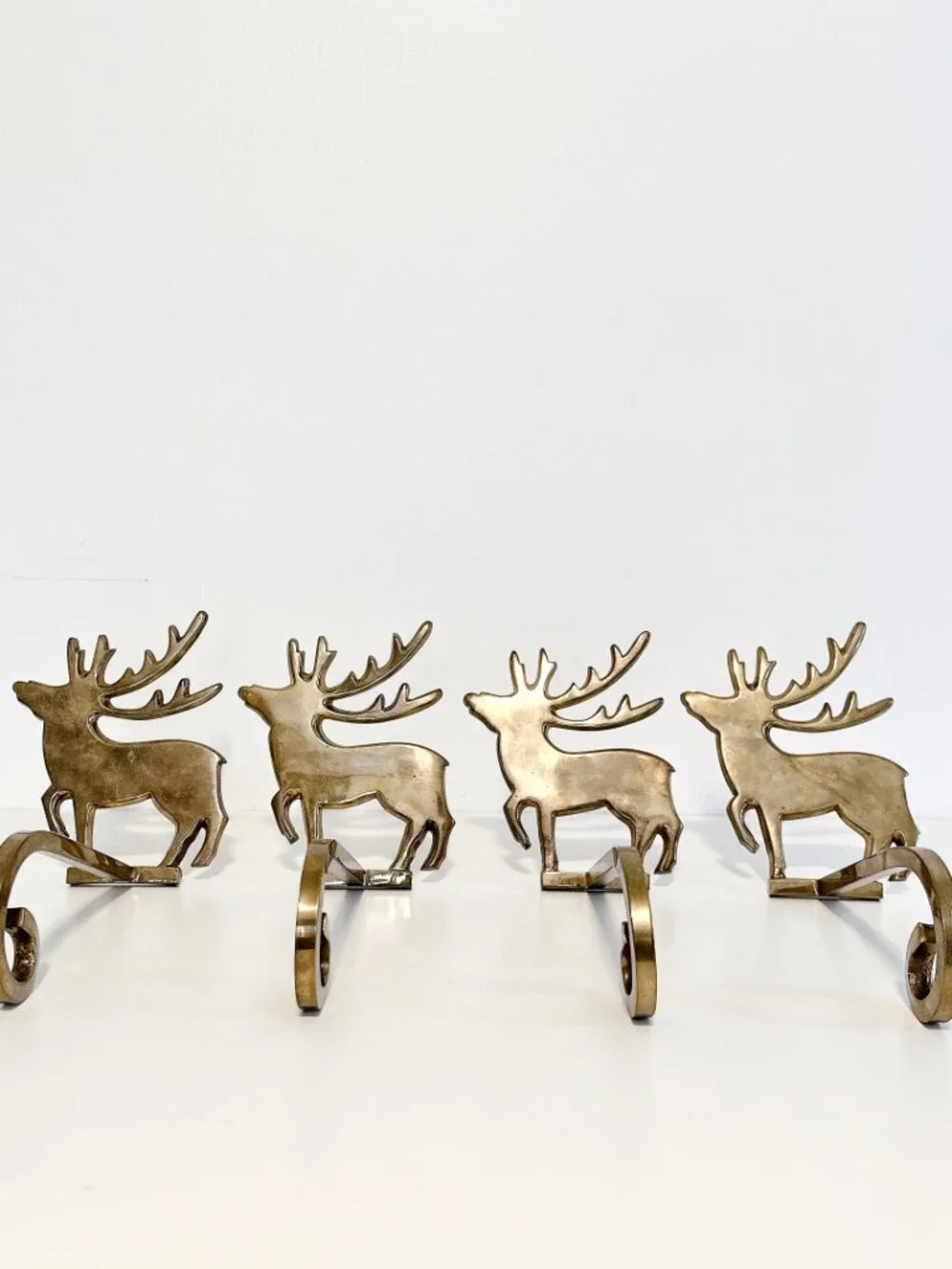 SET OF FOUR BRASS REINDEER MANTEL STOCKING HANGERS